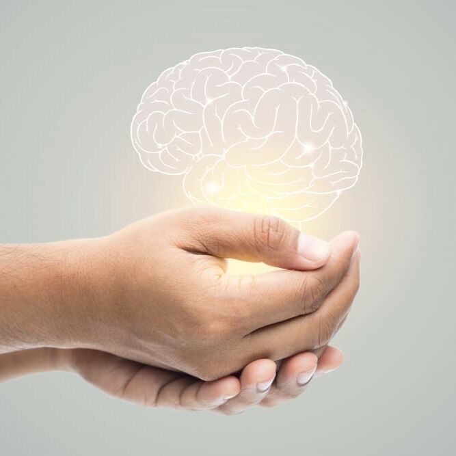 mental-health-day-man-holding-brain-illustration-on-gray-wall (1)